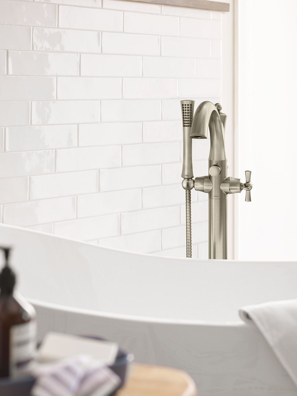 Wynford one-handle tub filler includes hand shower