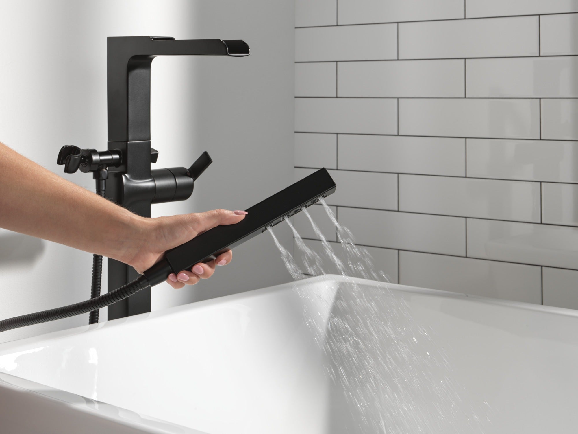 Delta Ara® Single Handle Floor Mount Channel Spout Tub Filler Trim with Hand Shower