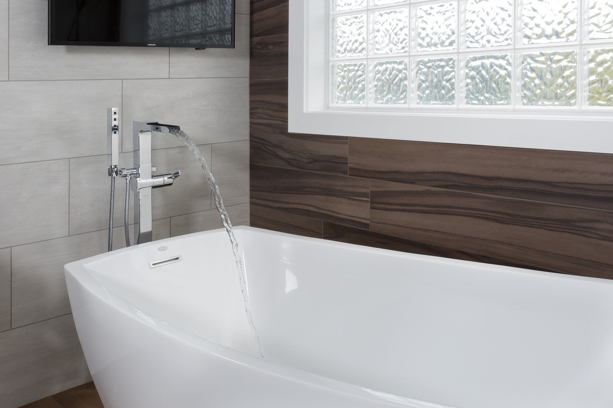Delta Ara® Single Handle Floor Mount Channel Spout Tub Filler Trim with Hand Shower