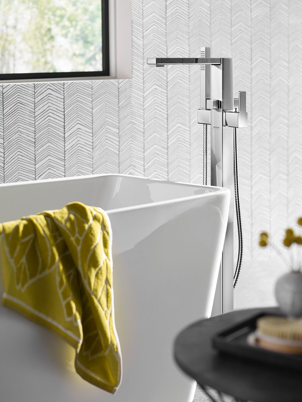90 Degree one-handle tub filler includes hand shower